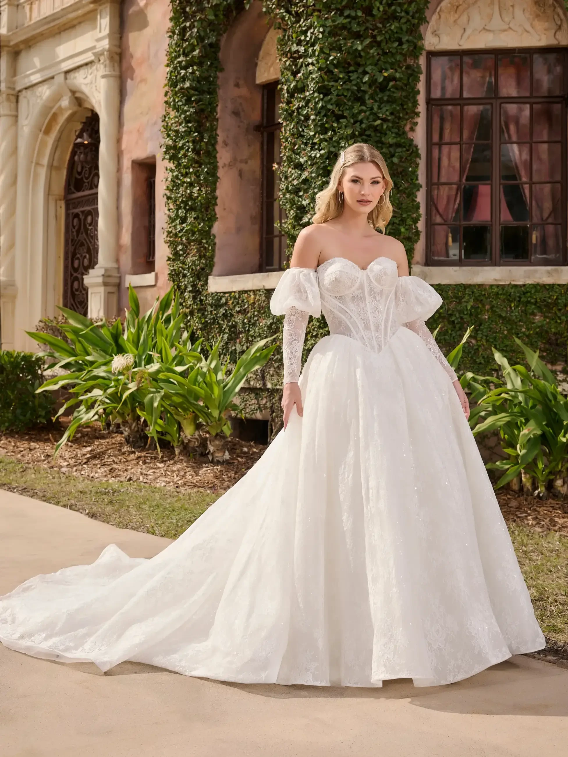 model is wearing an off the shoulder dropped waist wedding dress