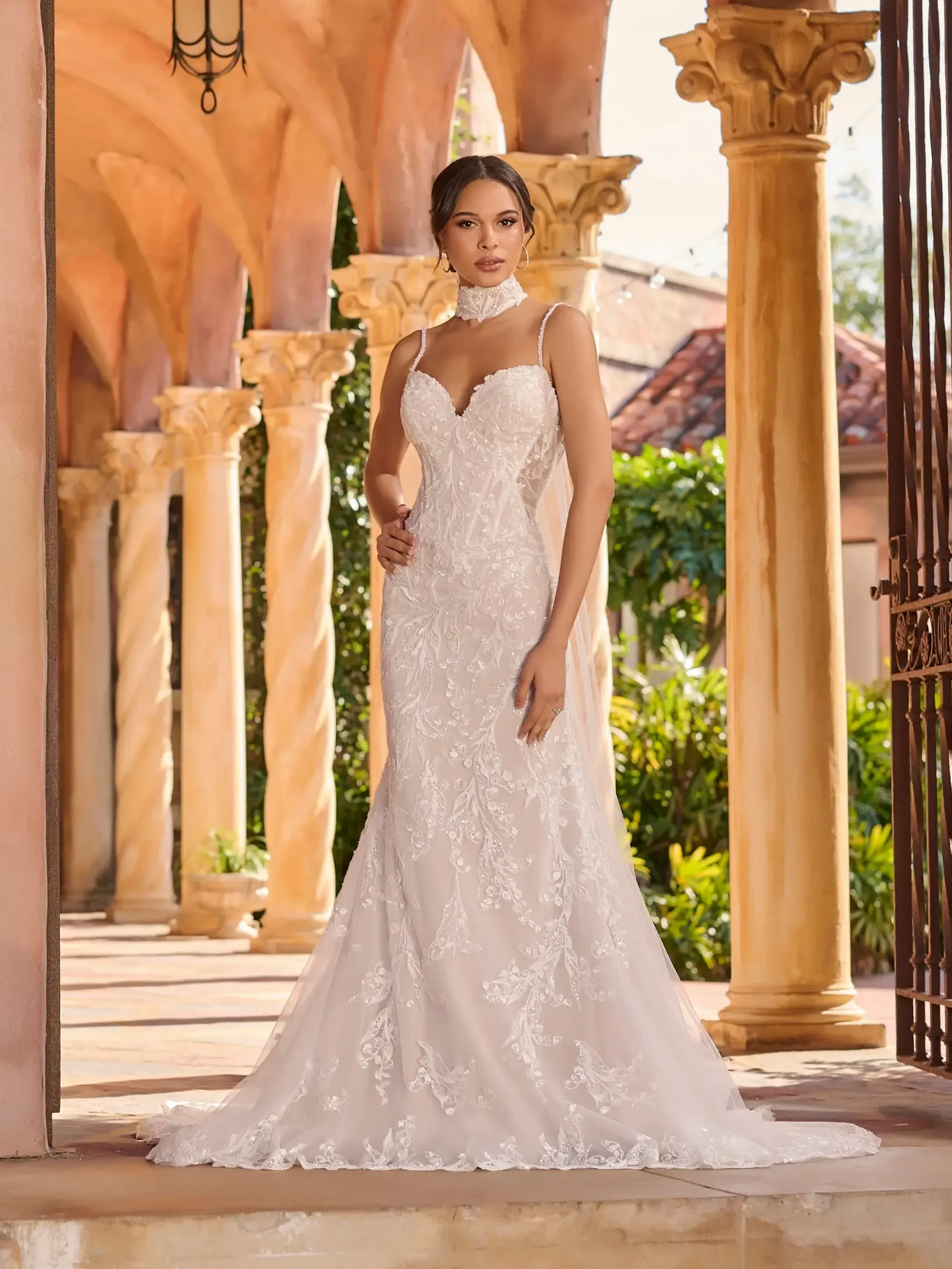 model is wearing a sleeveless lace wedding dress