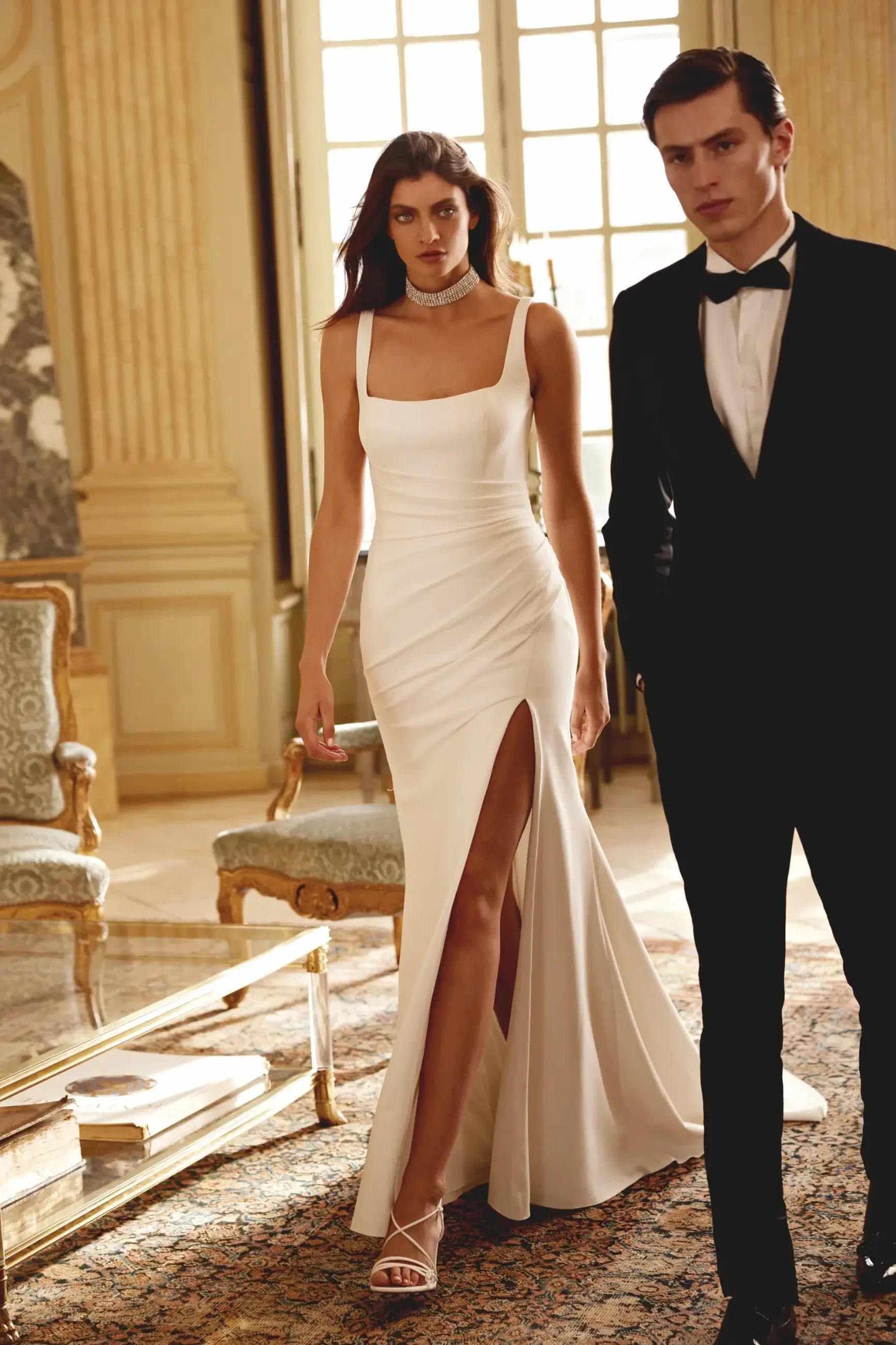 model is wearing a sleeveless square neckline satin fit and flare bridal gown