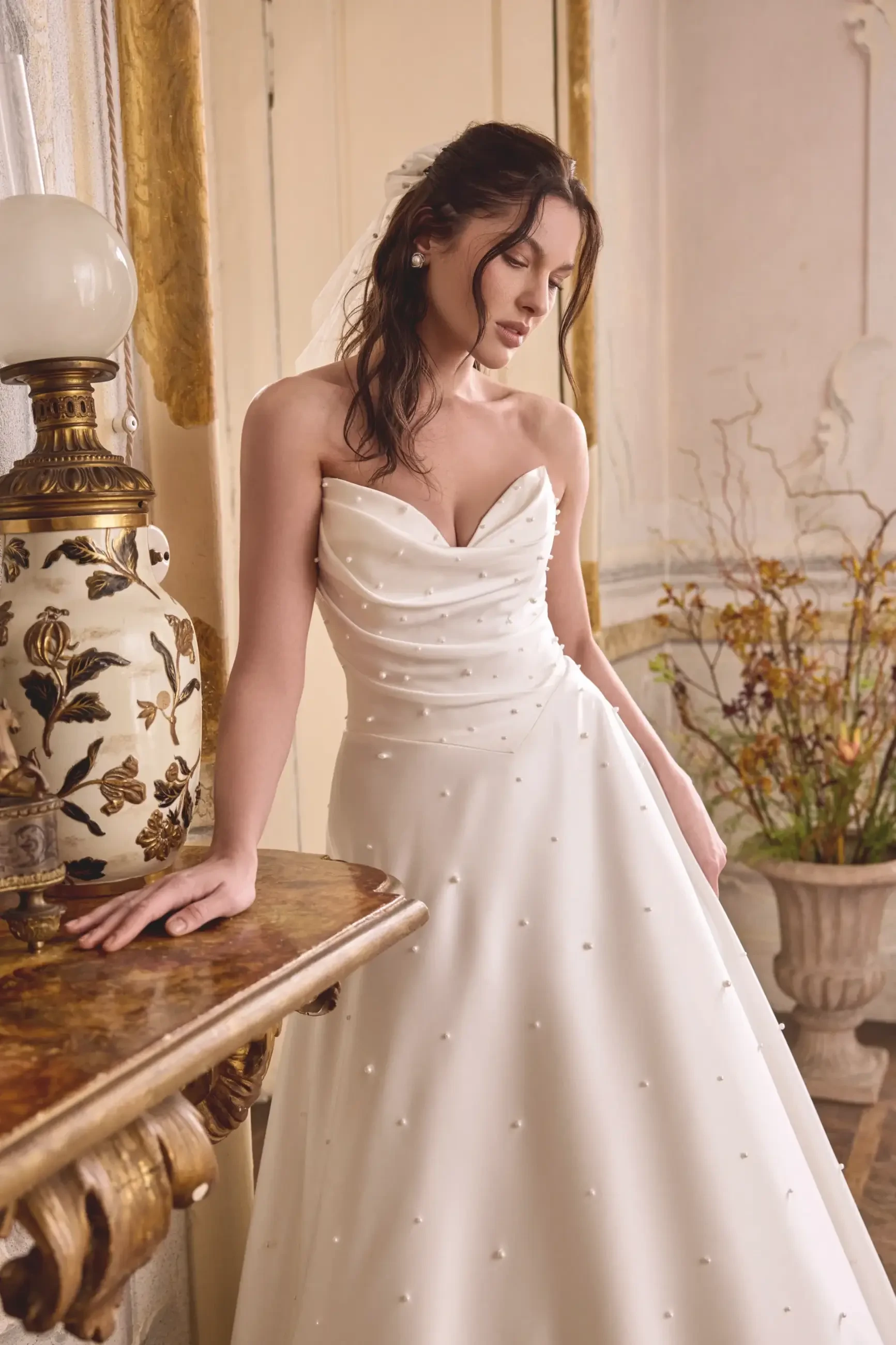 model is wearing a strapless a-line bridal gown