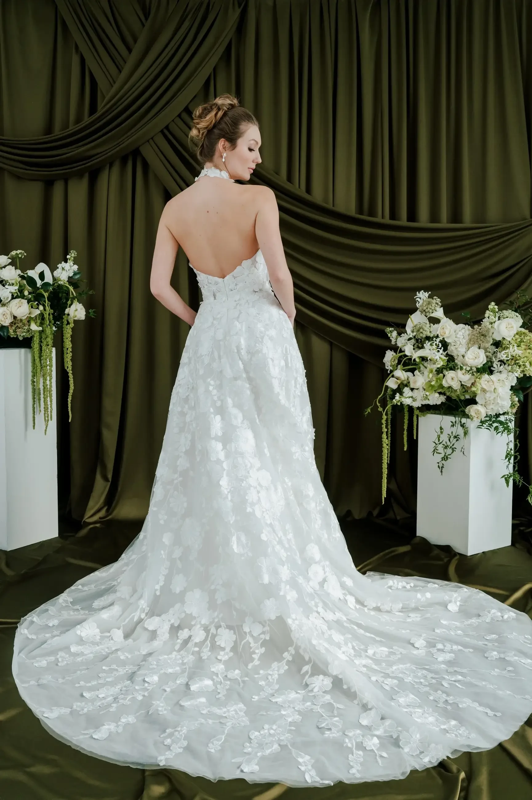 model is wearing a sleeveless halter wedding dress