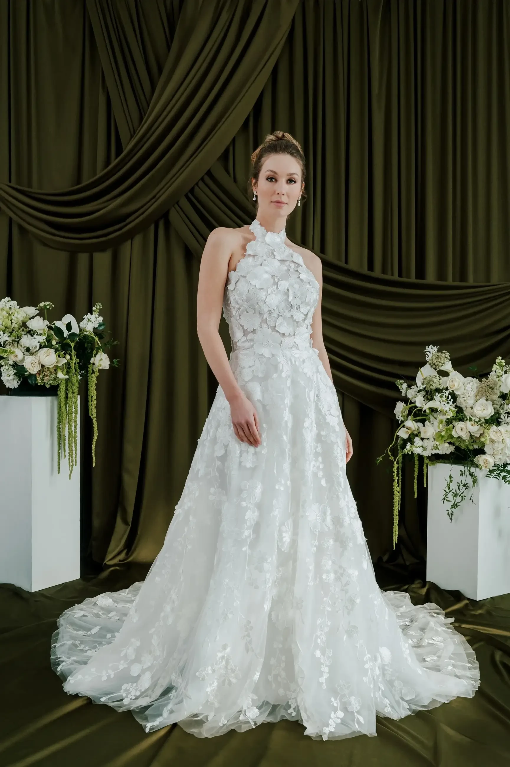 model is wearing a sleeveless halter wedding dress