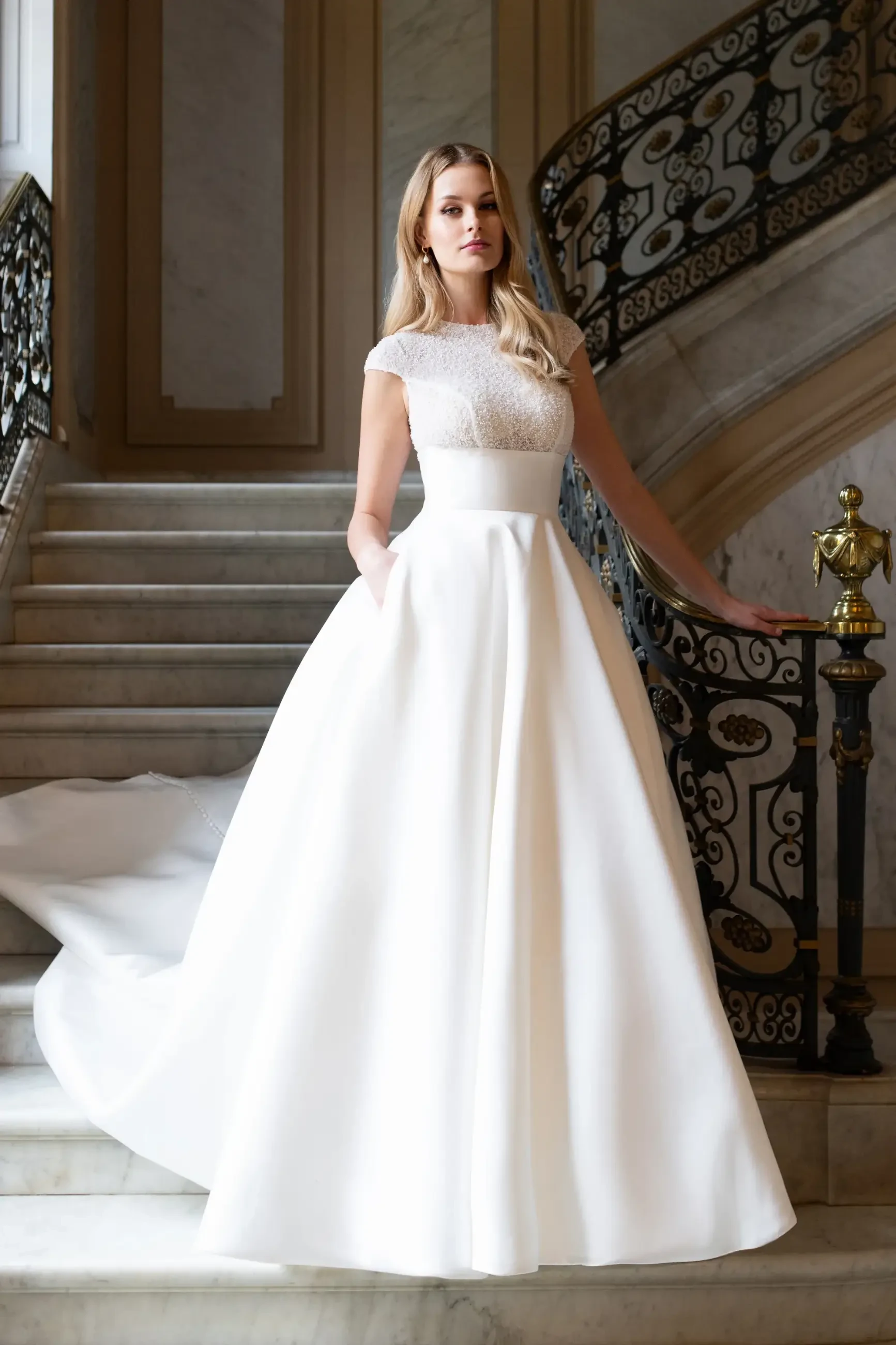 model is wearing a classic ball gown wedding dress