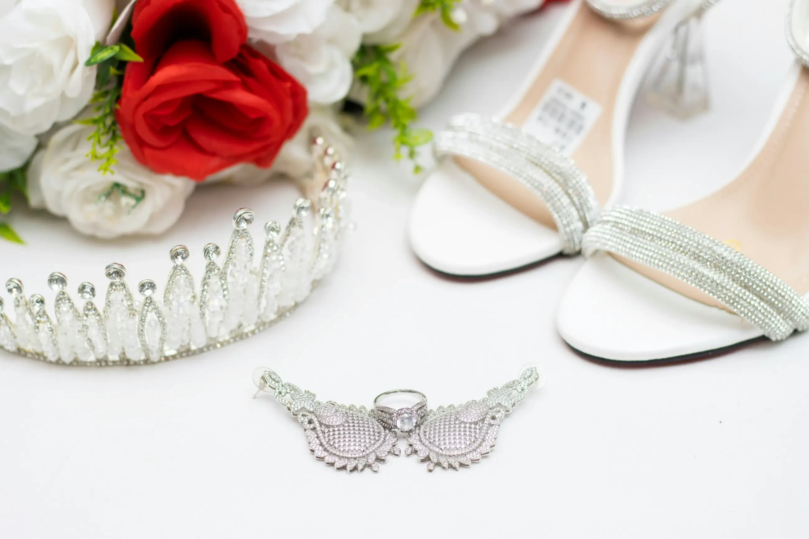 image shows bridal heels, a tiara, and other accessories