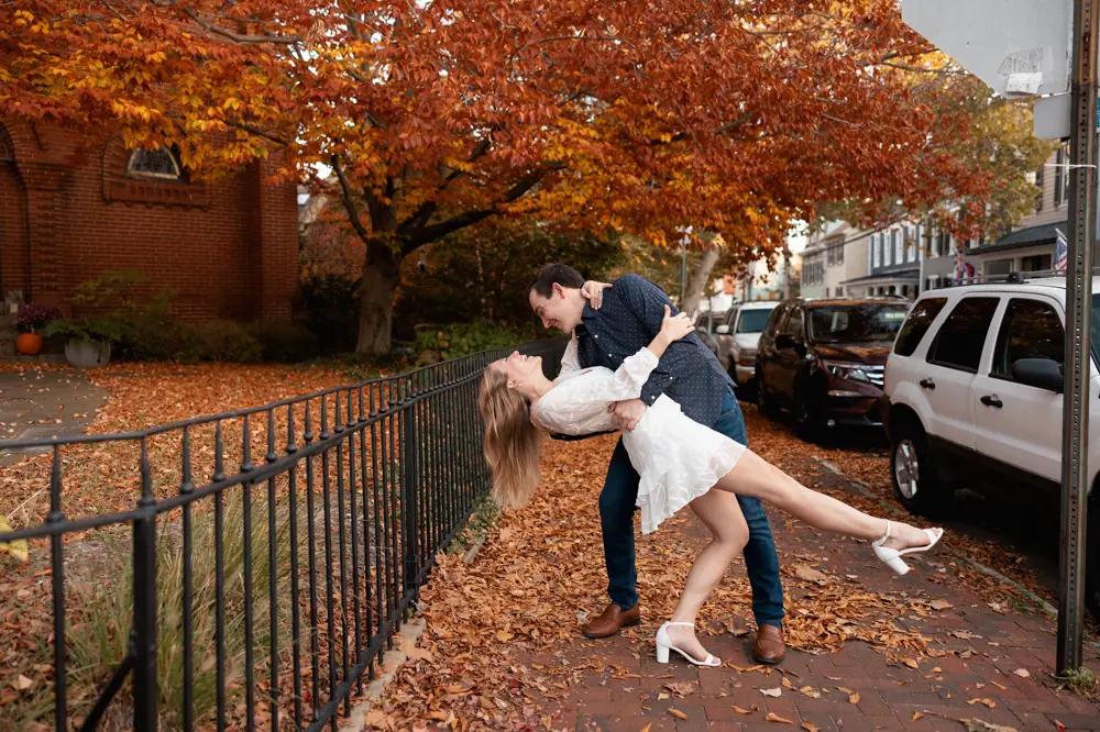 Photo of the real bride and groom posing on the autumn street