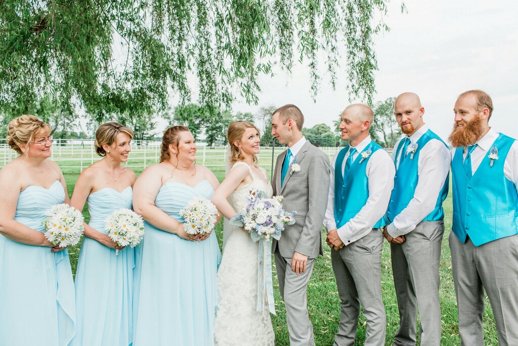 Photo of the bride and groom looking at each other and their friends